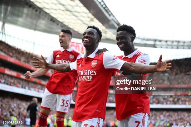 Arsenal's English striker Eddie Nketiah celebrates with teammates Arsenal's Brazilian striker Gabriel Martinelli and Arsenal's English midfielder...