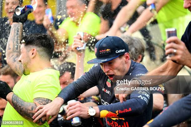 Red Bull's Dutch driver Max Verstappen tries to escape after posing for a team photo after winning the Spanish Formula One Grand Prix at the Circuit...