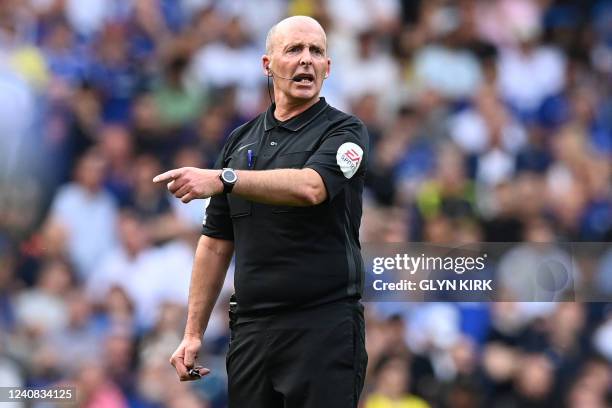 English referee Mike Dean gestures during the English Premier League football match between Chelsea and Watford at Stamford Bridge in London on May...