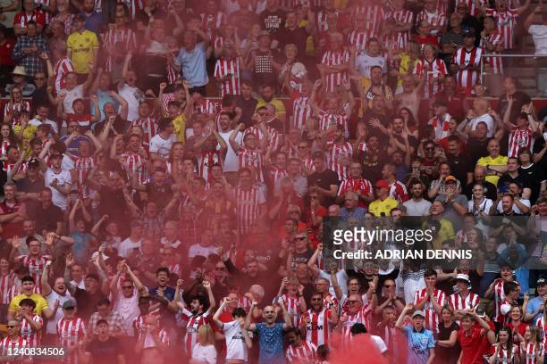 Brentford fans celebrate during the English Premier League football match between Brentford and Leeds United at Brentford Community Stadium in London...