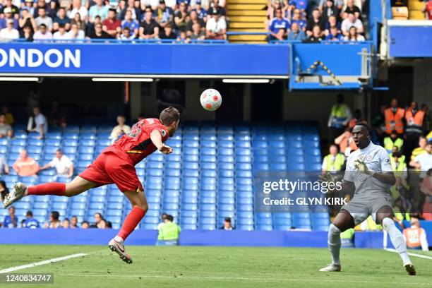 Watford's English midfielder Dan Gosling heads the ball past Chelsea's French-born Senegalese goalkeeper Edouard Mendy for their first goal during...
