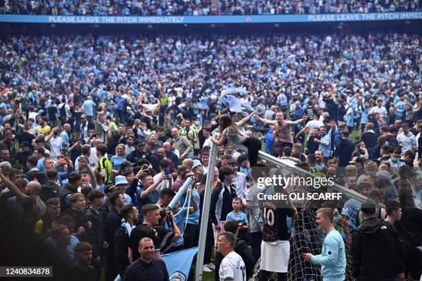 Manchester City's fans invades the pitch to celebrate after wining the English Premier League football match between Manchester City and Aston Villa...