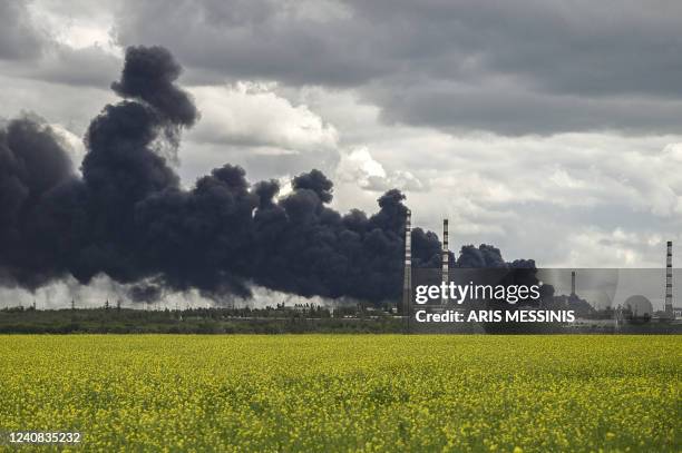 Smoke rises from an oil refinery after an attack outside the city of Lysychans'k in the eastern Ukranian region of Donbas, on May 22 on the 88th day...