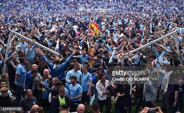 Manchester City's fans celebrate as they invade the pitch at the end of the English Premier League football match between Manchester City and Aston...