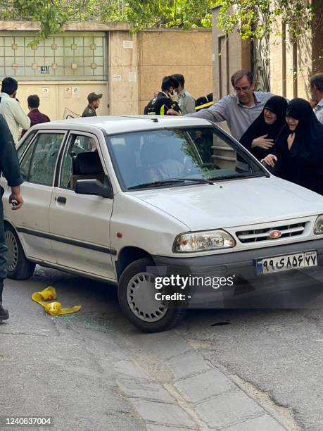 Graphic content / A picture shows two women mourning next to the body of Iranian Revolutionary Guards colonel Sayyad Khodai, after he was shot dead,...