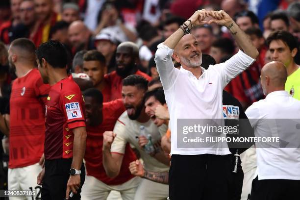 Milan's Italian head coach Stefano Pioli , AC Milan's French forward Olivier Giroud and teammates celebrate minutes to the end of the Italian Serie A...