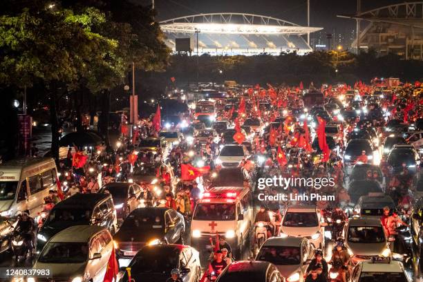 Football fans celebrate outside the My Dinh stadium as Vietnam successfully defended the SEA Games men's football gold medal after beating Thailand...