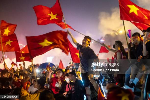 Football fans celebrate outside the My Dinh stadium as Vietnam successfully defended the SEA Games men's football gold medal after beating Thailand...