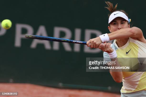 Switzerland's Belinda Bencic plays a backhand return to Hungary's Reka-Luca Jani during their women's singles match on day one of the Roland-Garros...