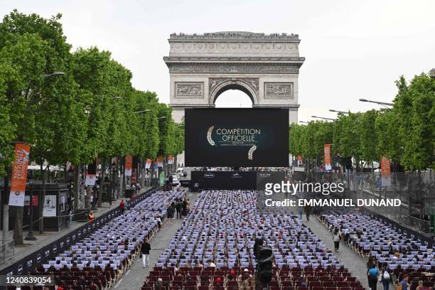 General view shows members of the public sitting in an open air cinema in front of a giant screen as they attend the third edition of "Sunday in...