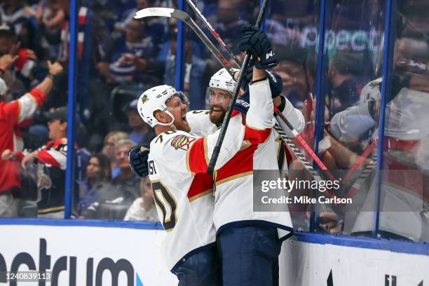 Aaron Ekblad of the Florida Panthers and Patric Hornqvist celebrate a goal against the Tampa Bay Lightning during the first period in Game Three of...