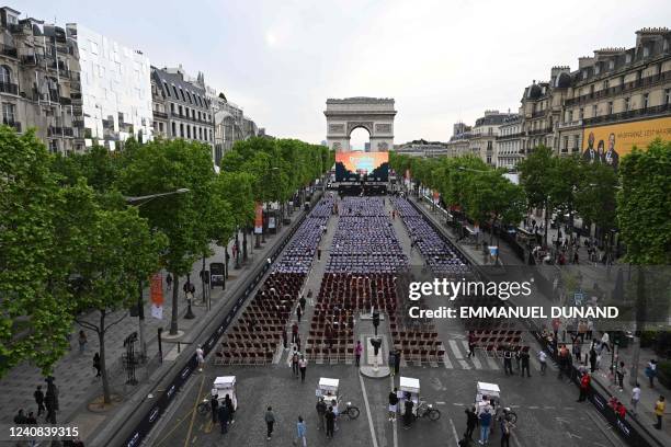 General view shows members of the public sitting in an open air cinema in front of a giant screen as they attend the third edition of "Sunday in...