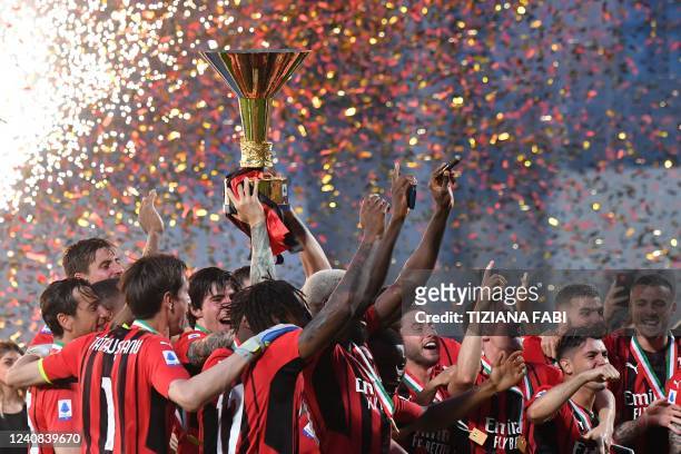 Milan's players celebrate with the winner's trophy after AC Milan won the Italian Serie A football match between Sassuolo and AC Milan, securing the...