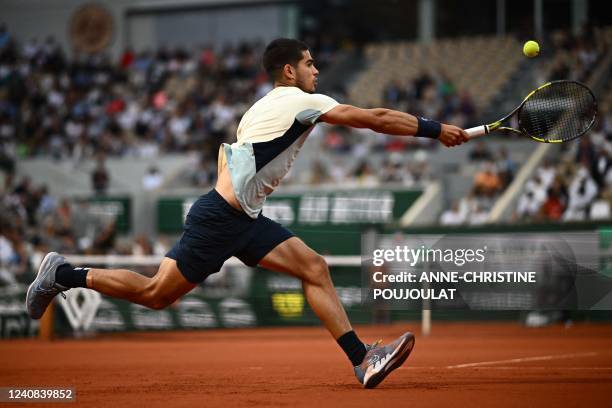 Spain's Carlos Alcaraz returns to Argentine's Juan Ignacio Londero during their men's singles match on day one of the Roland-Garros Open tennis...