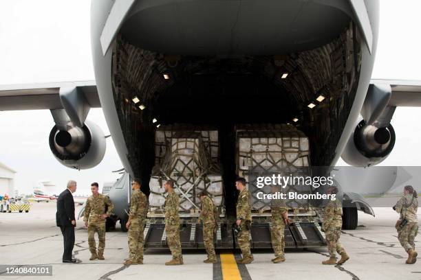 Tom Vilsack, US agriculture secretary, left, greets members of the United States Transportation Command at Indianapolis International Airport in...