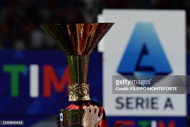 Milan's players celebrate with the winner's trophy after AC Milan won the Italian Serie A football match between Sassuolo and AC Milan, securing the...