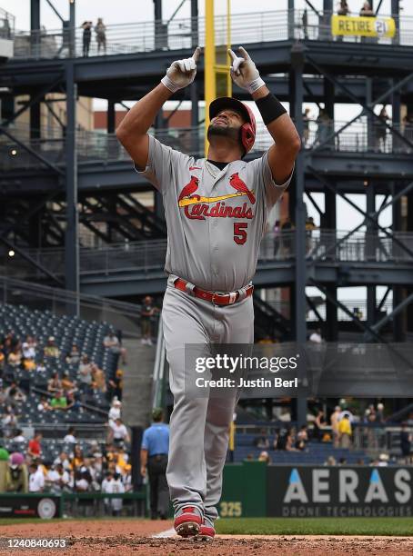 Albert Pujols of the St. Louis Cardinals reacts as he crosses home plate after hitting a solo home run in the fifth inning during the game against...