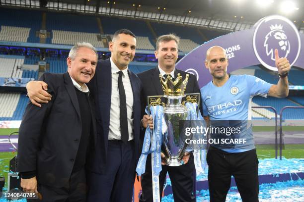 Manchester City's Spanish manager Pep Guardiola and Manchester City Emirati chairman Khaldoon al-Mubarak celebrate with the Premier league trophy on...