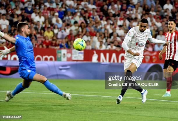 Sevilla's Moroccan forward Youssef En-Nesyri challenges Athletic Bilbao's Spanish goalkeeper Unai Simon during the Spanish League football match...