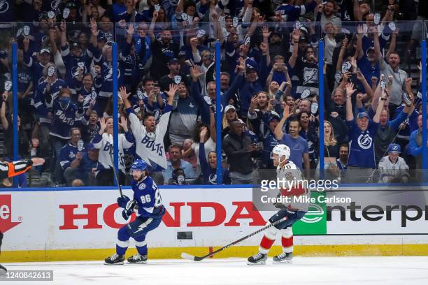 Nikita Kucherov of the Tampa Bay Lightning scores as Patric Hornqvist of the Florida Panthers reacts during the third period in Game Three of the...