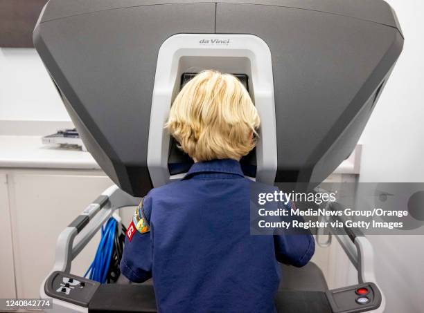 Cub Scout Tyler Linderman works the controls of a daVinci surgical robot at Placentia-Linda Hospital in Placentia on Thursday, May 19, 2022. During...