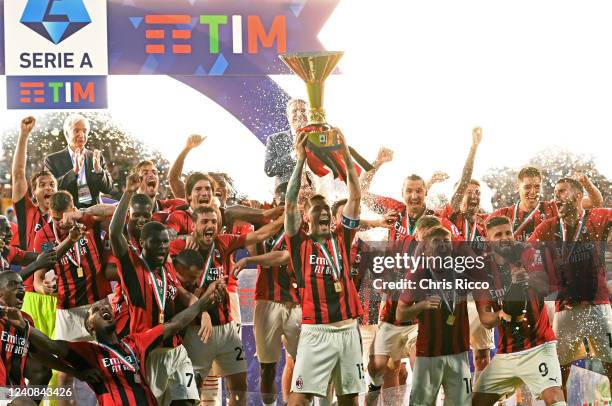 Alessio Romagnoli of AC Milan lifts the Serie A Scudetto trophy after their side finished the season as Serie A champions during the Serie A match...