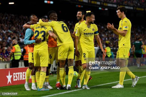 Villarreal's Spanish midfielder Moises Gomez celebrates with teammates after scoring his team's second goal during the Spanish League football match...