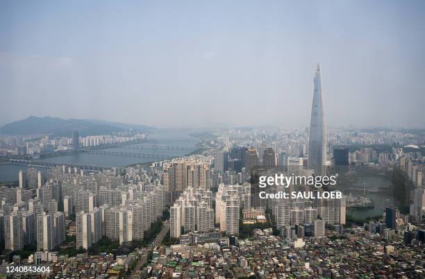 The Lotte World Tower, the tallest building in South Korea and sixth tallest in the world at 123 stories tall, is seen from the air over Seoul, South...