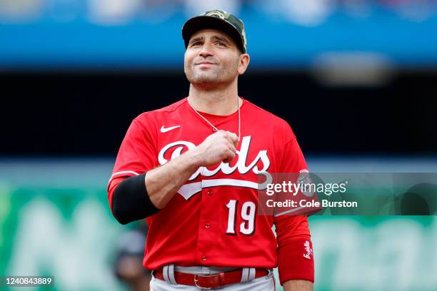 Joey Votto of the Cincinnati Reds smiles in the outfield in the ninth inning of their MLB game against the Toronto Blue Jays at Rogers Centre on May...