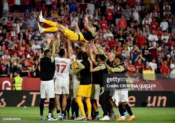 Sevilla's Moroccan goalkeeper Yassine Bounou "Bono" is lifted by teammates at the end of the Spanish League football match between Sevilla FC and...