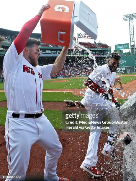 Boston Red Sox's Franchy Cordero is doused by Christian Arroyo after his walk off grand slam during the 10th inning of the game against the Seattle...