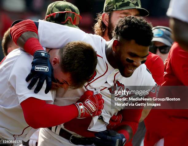 Boston Red Sox's Franchy Cordero is mobbed by his teammates after hitting a walk off grand slam during the 10th inning of the game against the...