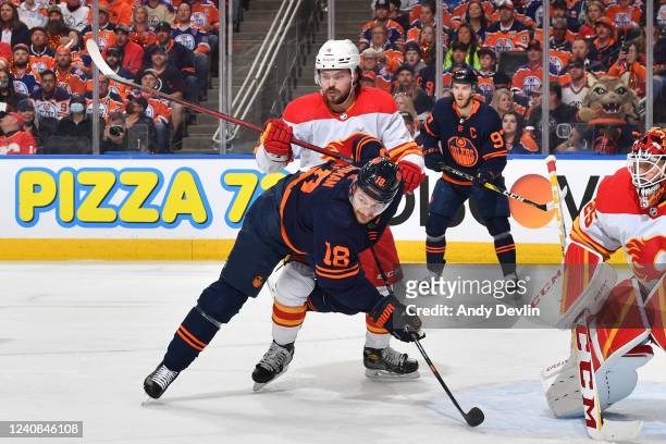 Zach Hyman of the Edmonton Oilers battles for position against Rasmus Andersson of the Calgary Flames during Game One of the Second Round of the 2022...