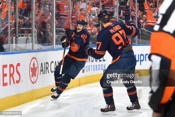 Zach Hyman and Connor McDavid of the Edmonton Oilers celebrate after a goal during Game One of the Second Round of the 2022 Stanley Cup Playoffs...