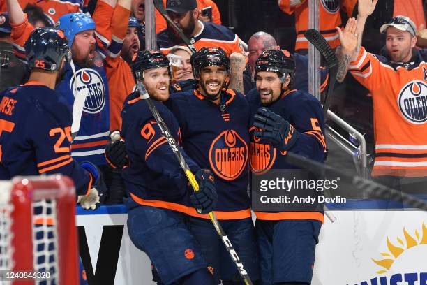 Evander Kane, Connor McDavid and Cody Ceci of the Edmonton Oilers celebrate after a goal during Game One of the Second Round of the 2022 Stanley Cup...