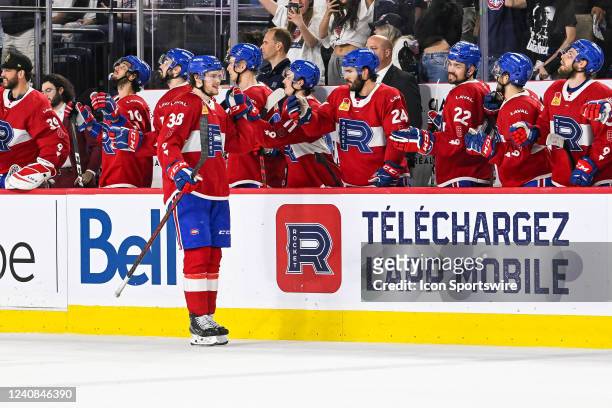 Laval Rocket center Nate Schnarr celebrates his goal with his teammates at the bench during the game 1 of round 3 of the Calder Cup Playoffs between...