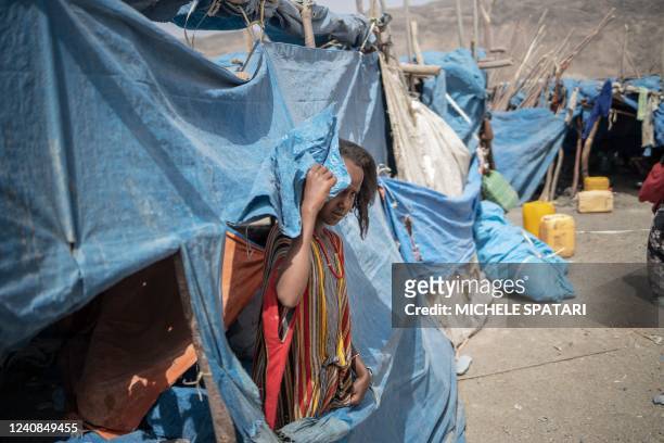 An internally displaced child peeks from a tent at the internally displaced persons camp of Guyah, 100 kms of Semera, Afar region, Ethiopia on May...