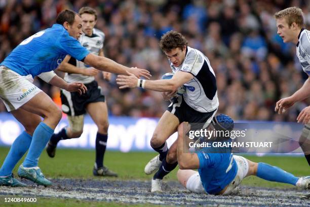 Scotland's Thom Evans tackled by Italy's Leonardo Giraldini and Sergio Parisse during a Six Nations international rugby union match at Murrayfield...