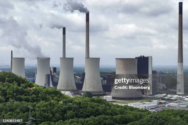 Chimneys and a cooling tower emit vapor at the Scholven coal-fired power plant operated by Uniper SE in Gelsenkirchen, Germany, on Saturday, May 21,...