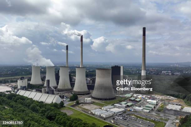 Chimneys and a cooling tower emit vapor at the Scholven coal-fired power plant operated by Uniper SE in Gelsenkirchen, Germany, on Saturday, May 21,...