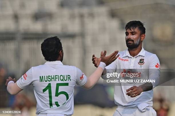 Bangladesh's Mushfiqur Rahim celebrates after scoring a century with his teammate Liton Das during the first day of the second Test cricket match...