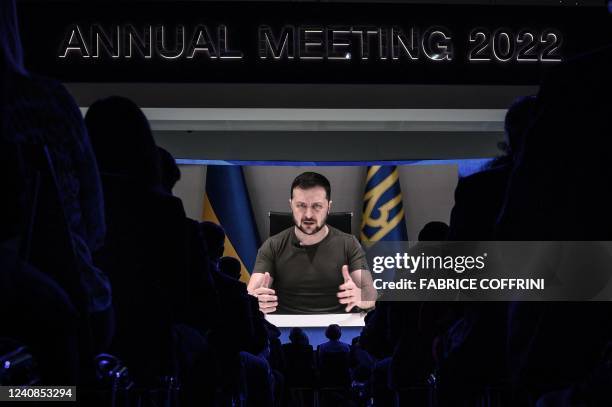 Ukrainia's President Volodymyr Zelensky appears on a giant screen during his address by video conference as part of the World Economic Forum annual...