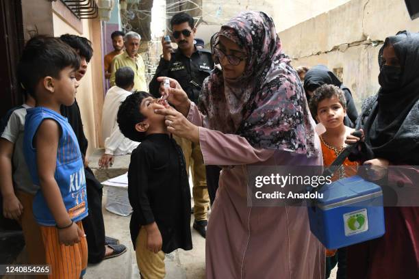 Pakistani health worker administers polio drops to child during an anti-polio campaign in Karachi, Pakistan, on May 23, 2022. Pakistani authorities...