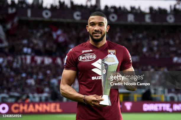 Gleison Bremer of Torino FC poses for a photo with the Serie A MVP Best Defender 2021/2022 award prior to the Serie A football match between Torino...