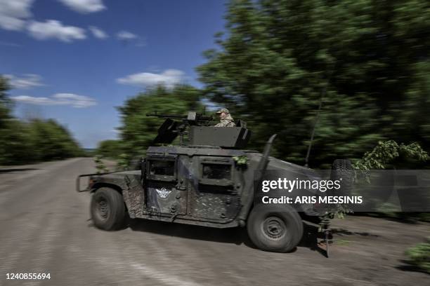 Ukrainian servicemen move toward the frontline at a checkpoint near the city of Lysychansk in the eastern Ukranian region of Donbas, on May 23 amid...