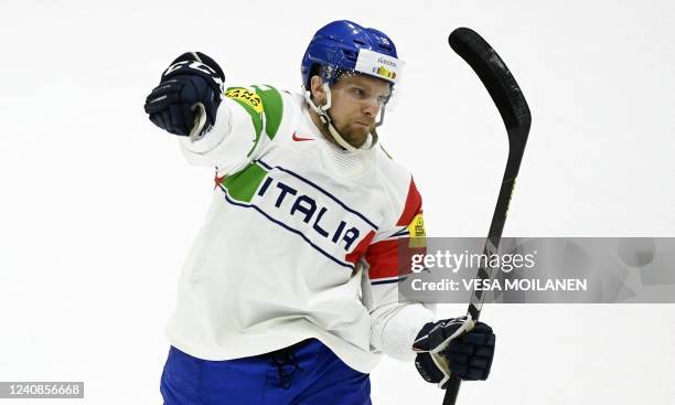 Italy's defender Enrico Miglioranzi celebrates scoring during the 2022 IIHF Ice Hockey World Championships preliminary round group A match between...