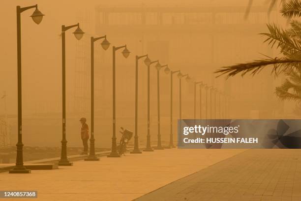 Man stands on the bank of the Shatt al-Arab waterway, formed at the confluence of the Euphrates and Tigris rivers, in Iraq's southern city of Basra...