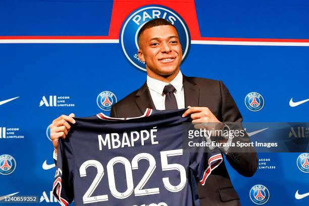 Kylian Mbappe poses for photos with 2025 PSG t-shirt indicates his new contract during the Press Conference of Paris Saint-Germain at Parc des...
