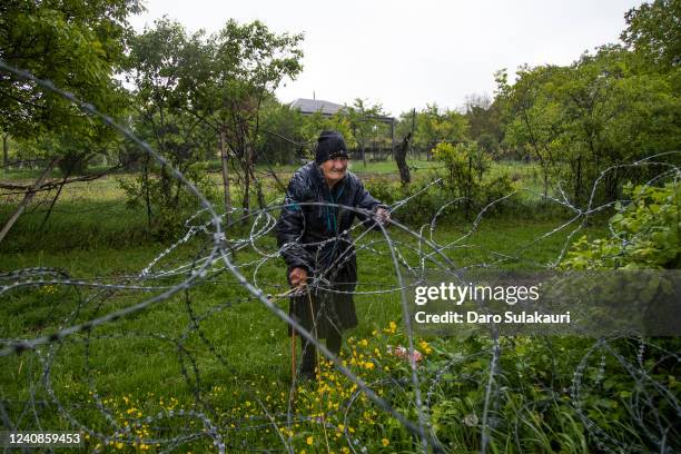 Georgia-born 88-year old farmer, Valia Valishvili, stands on the Russian controlled territory of South Ossetia in Khurvaleti village on May 23, 2022...