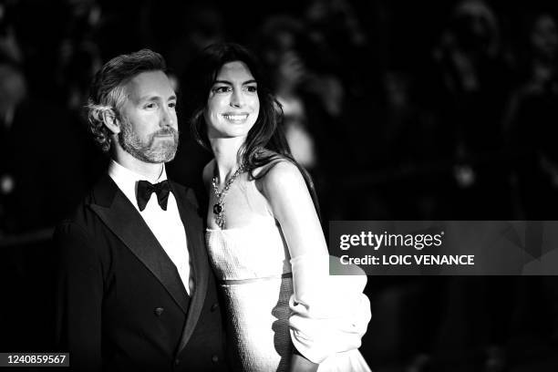 Actress Anne Hathaway and her husband Adam Shulman pose as they leave the Festival Palace following the screening of the film "Armageddon Time"...